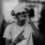 A man is smoking while listening to music.
