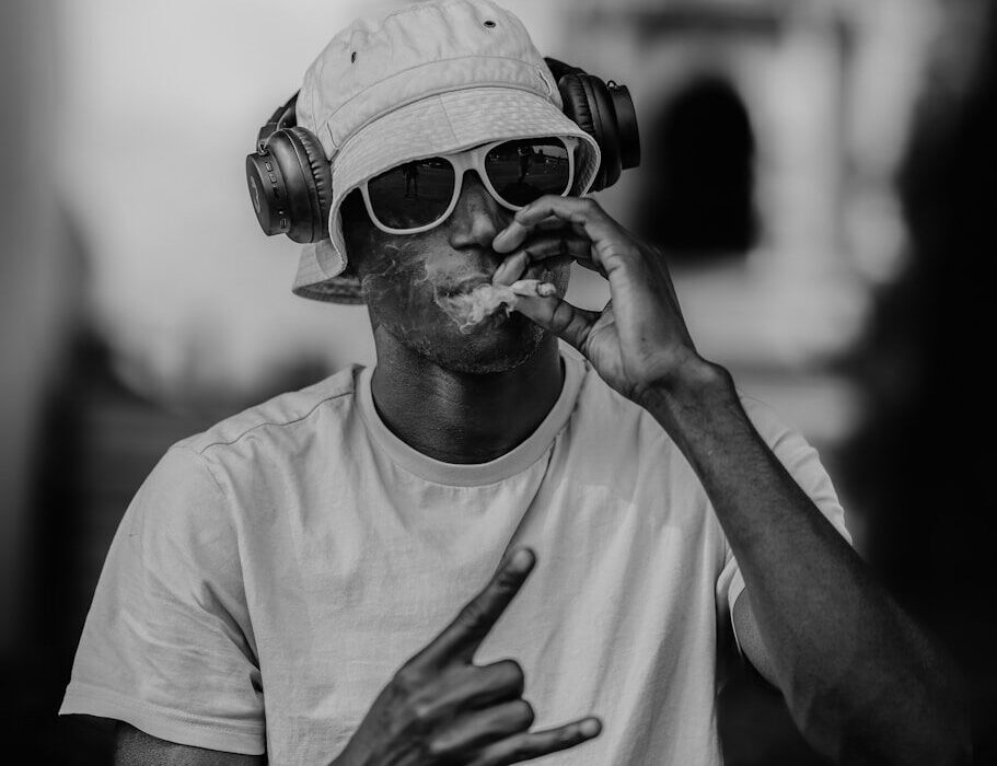 A man is smoking while listening to music.