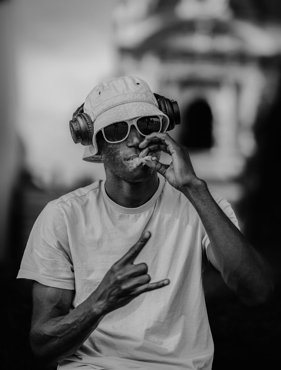 A man is smoking while listening to music.
