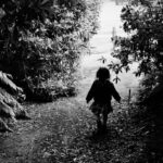 a little girl that is walking down a path