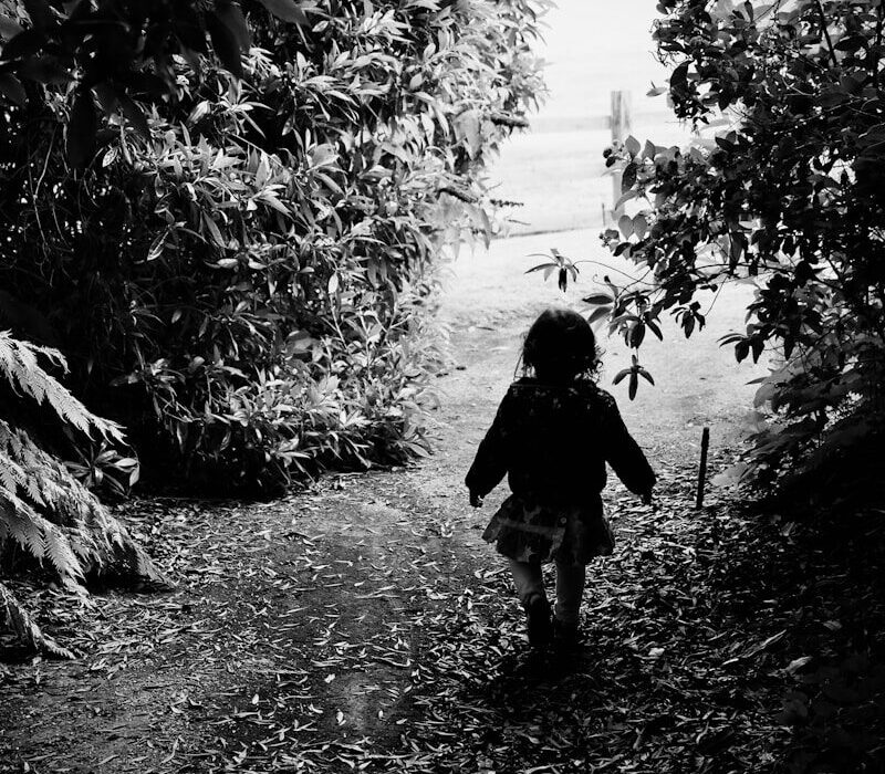 a little girl that is walking down a path