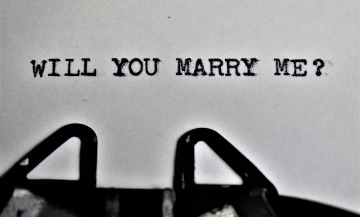 a close up of a typewriter with the words will you marry me?